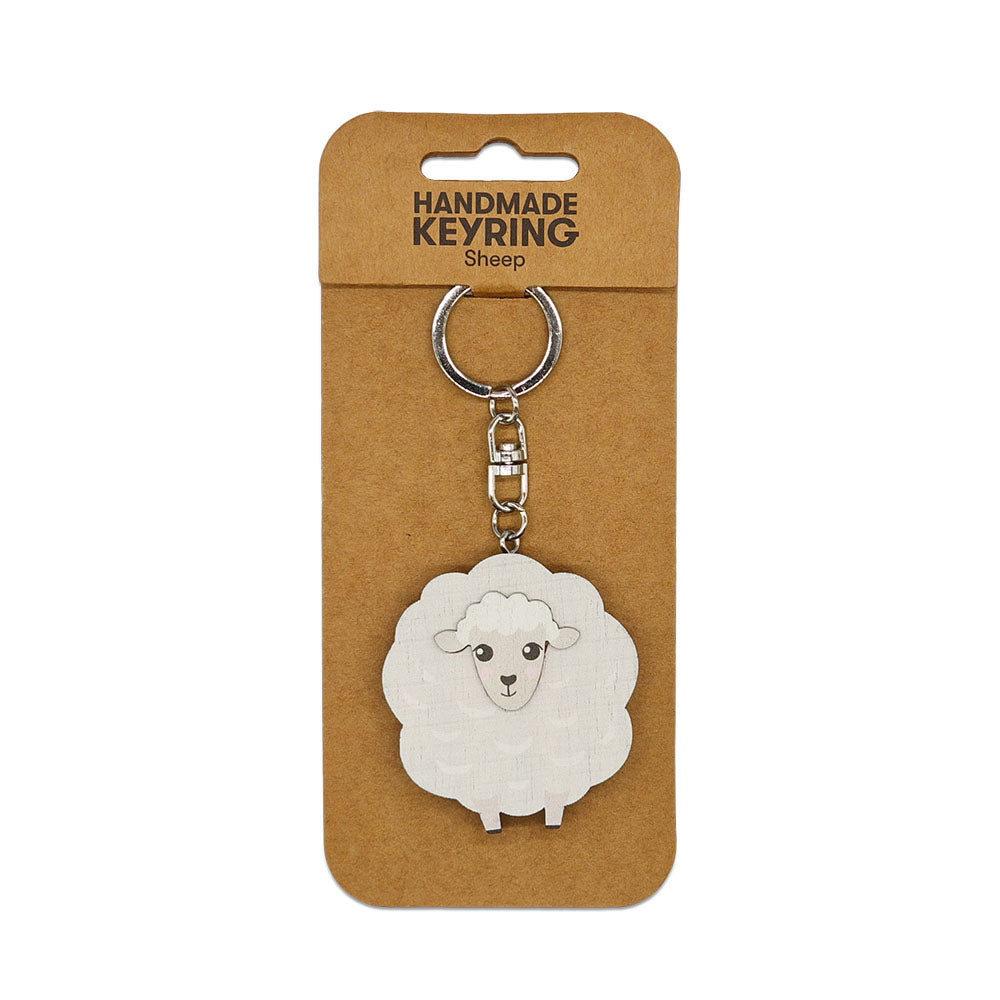 The Sheep Wooden Keyring features a cartoon-style sheep charm on a sturdy metal ring and chain, presented on brown card labeled HANDMADE KEYRING Sheep—a charming handmade Aotearoa keepsake.