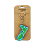 The NZ Map Wooden Keyring features a handmade New Zealand map design with green patterns and comes attached to packaging labeled Handmade Keyring NZ Map.