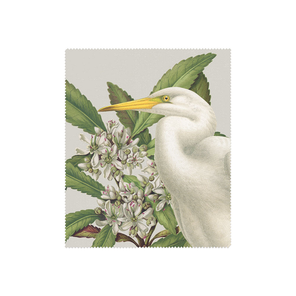 A detailed illustration of a white egret with a yellow beak amid green botanicals and white flowers, featured in the Set of 3 Birds & Botanicals Collection Lens Cloths—ideal for nature lovers and bird enthusiasts.