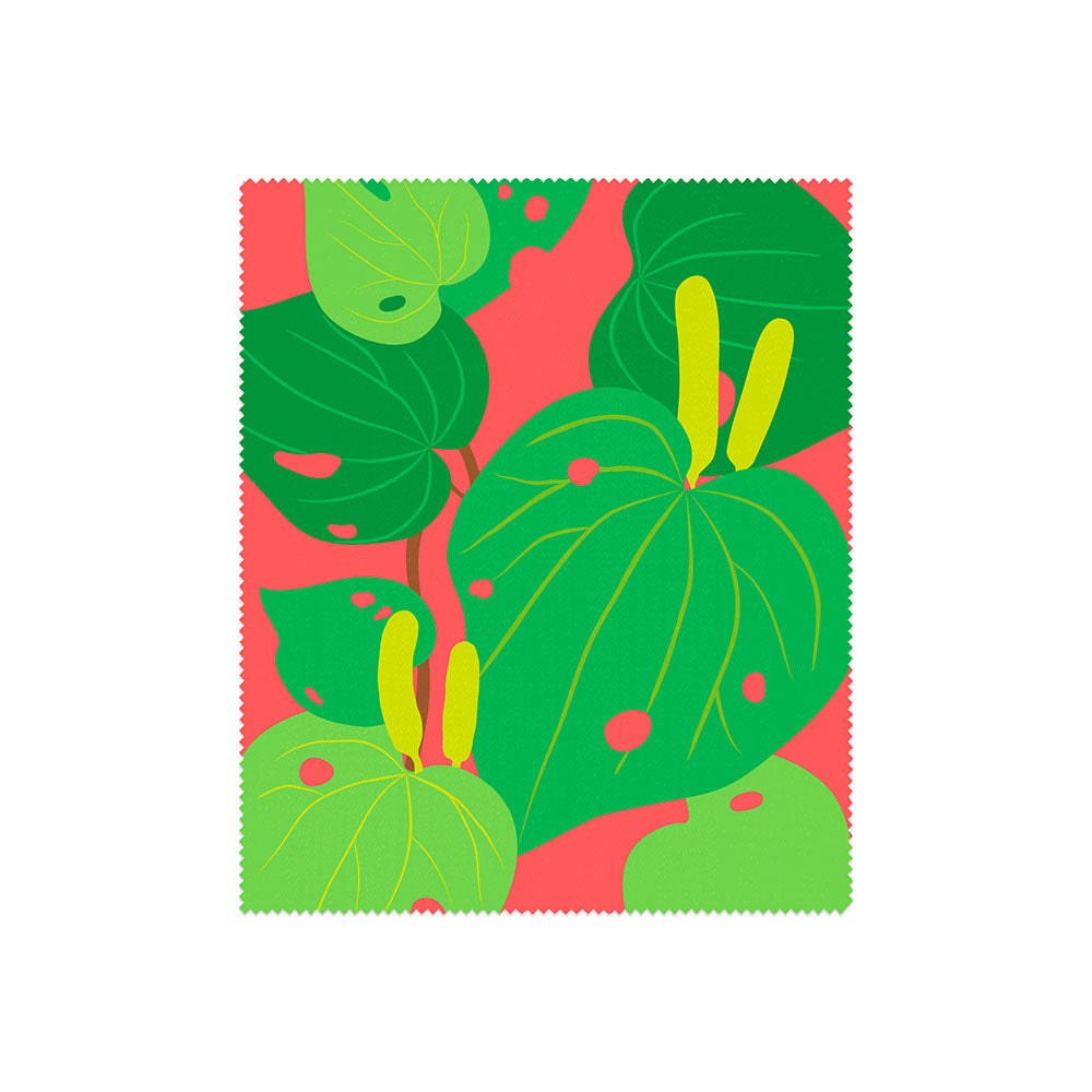 A set of 4 lens cloths from the Bright Botanical Collection, each with bold green leaf and yellow spadix designs on a red background and zigzag edges inspired by New Zealand’s vibrant flora.