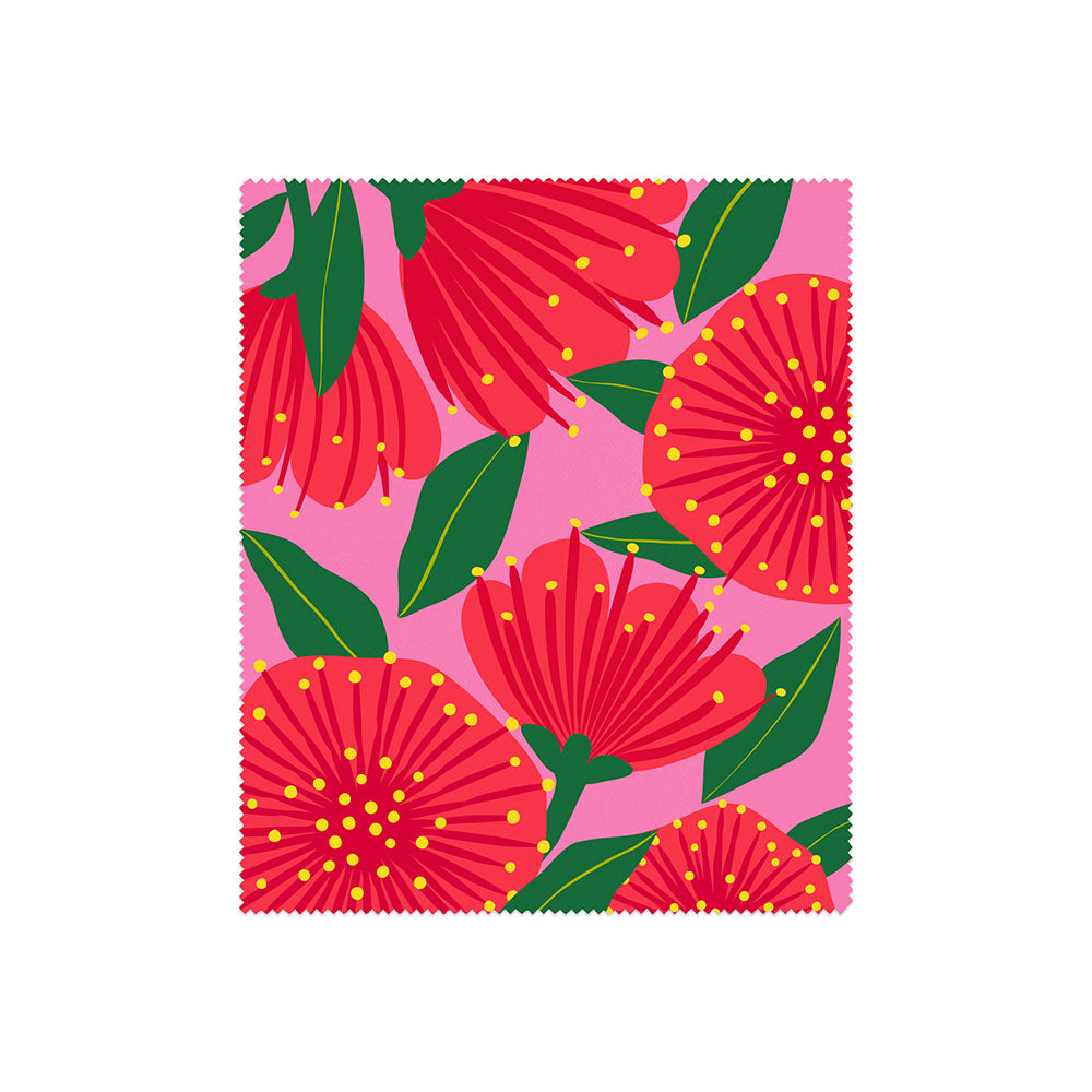 This set of 4 lens cloths from the Bright Botanical Collection features playful zigzag edges and vibrant, stylized floral patterns inspired by New Zealand’s flora, with bold red flowers, green leaves, and yellow dots on a pink background.