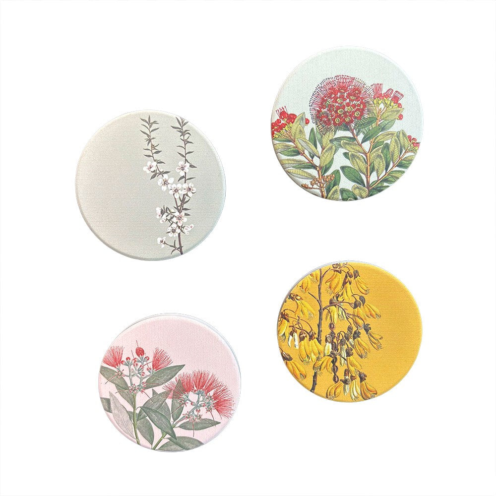 Vintage Botanical Ceramic Magnet Set features four round magnets with botanical illustrations—white blossoms, red flowers with green leaves, red and white blooms, and clusters of yellow flowers—printed in New Zealand.