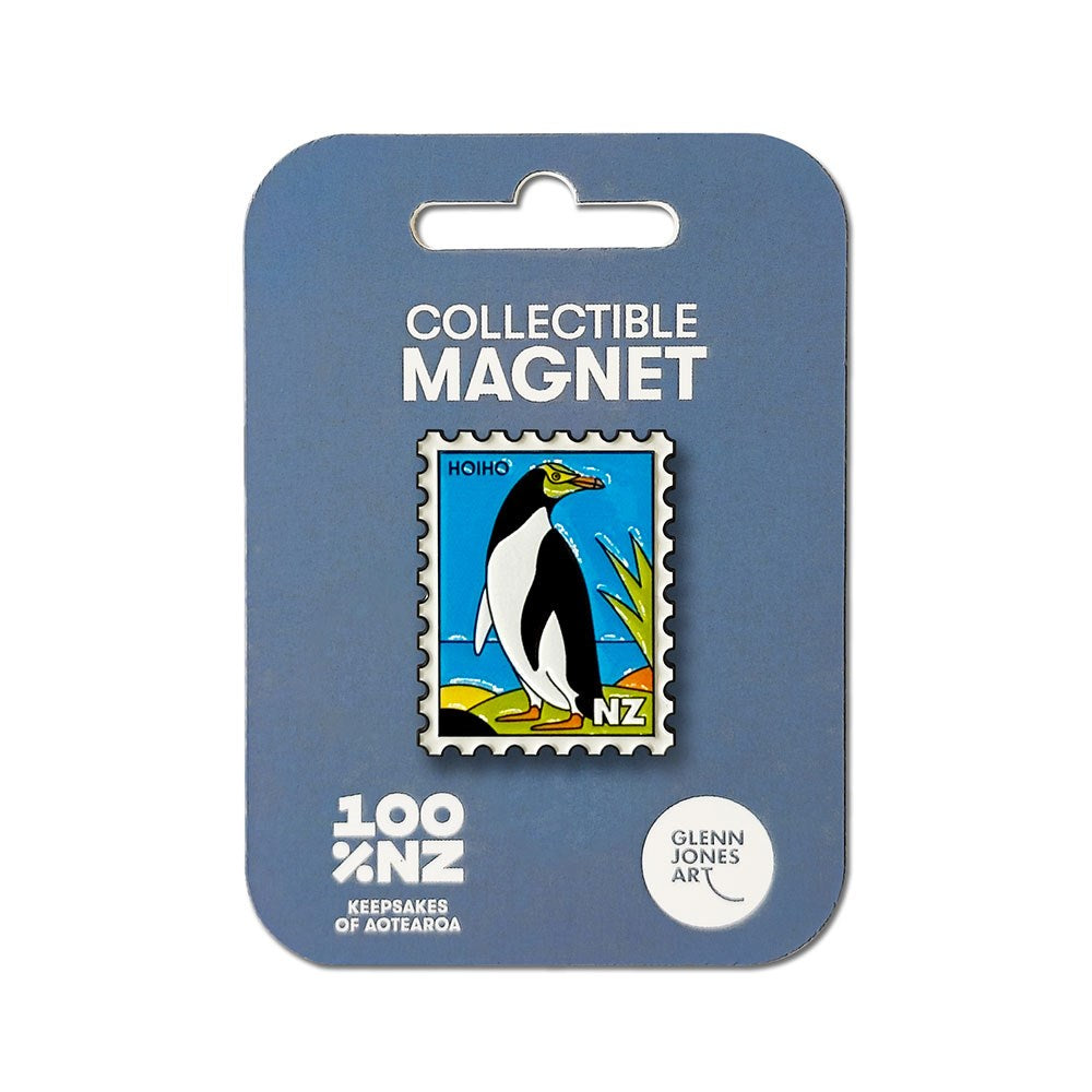 The Hoiho Collectible Stamp Magnet is shaped like a postage stamp and showcases a delightful illustration of a yellow-eyed penguin, or hoiho, along with the letters NZ to celebrate New Zealand’s unique wildlife. It comes attached to blue packaging labeled "Collectible Magnet" and "Glenn Jones Art.