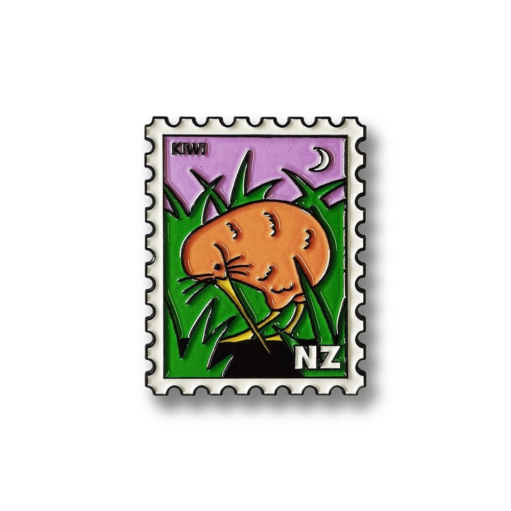 The Kiwi Collectible Stamp Magnet showcases classic Glenn Jones art: a kiwi bird amidst green grass, under a purple sky with a crescent moon and NZ in the corner. KIWI appears at the top left, capturing vibrant New Zealand charm.