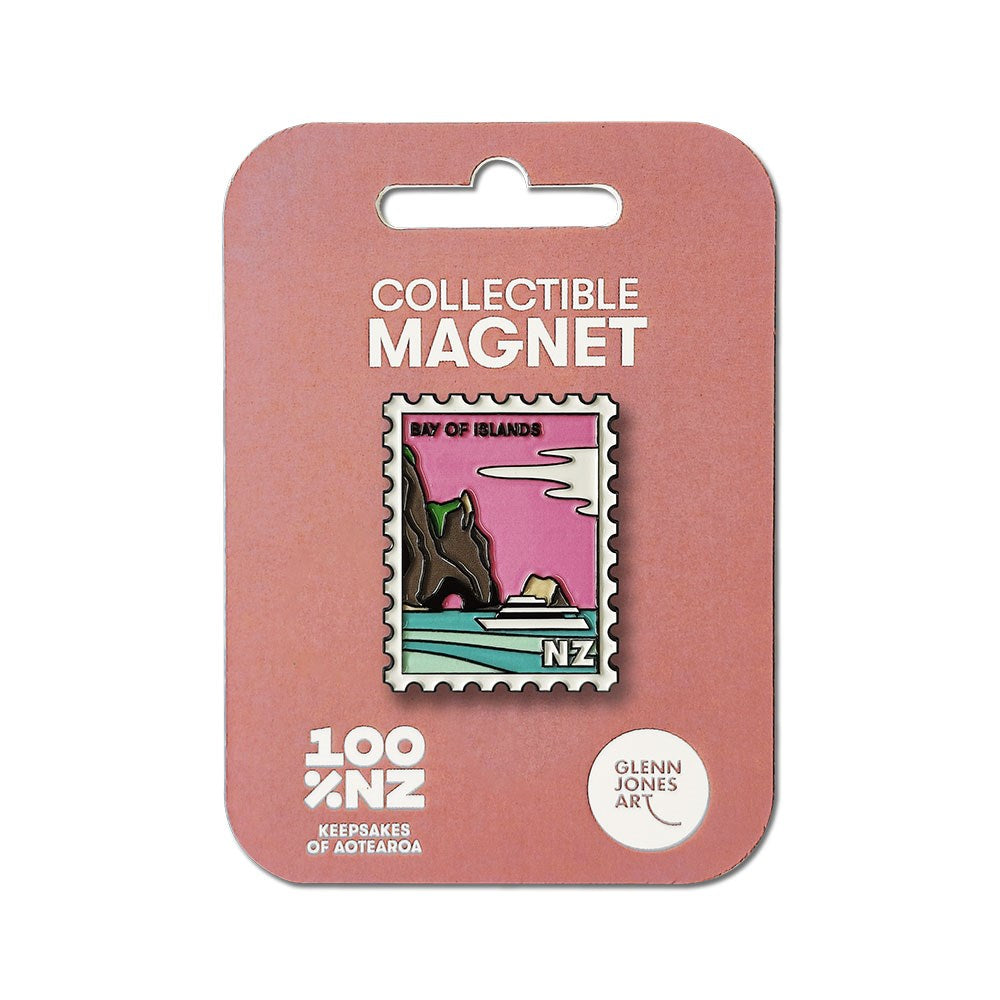 The Bay of Islands Collectible Stamp Magnet by Glenn Jones features a postage stamp shape with a Bay of Islands landscape and NZ label, packaged on pink card marked Collectible Magnet and 100% NZ.