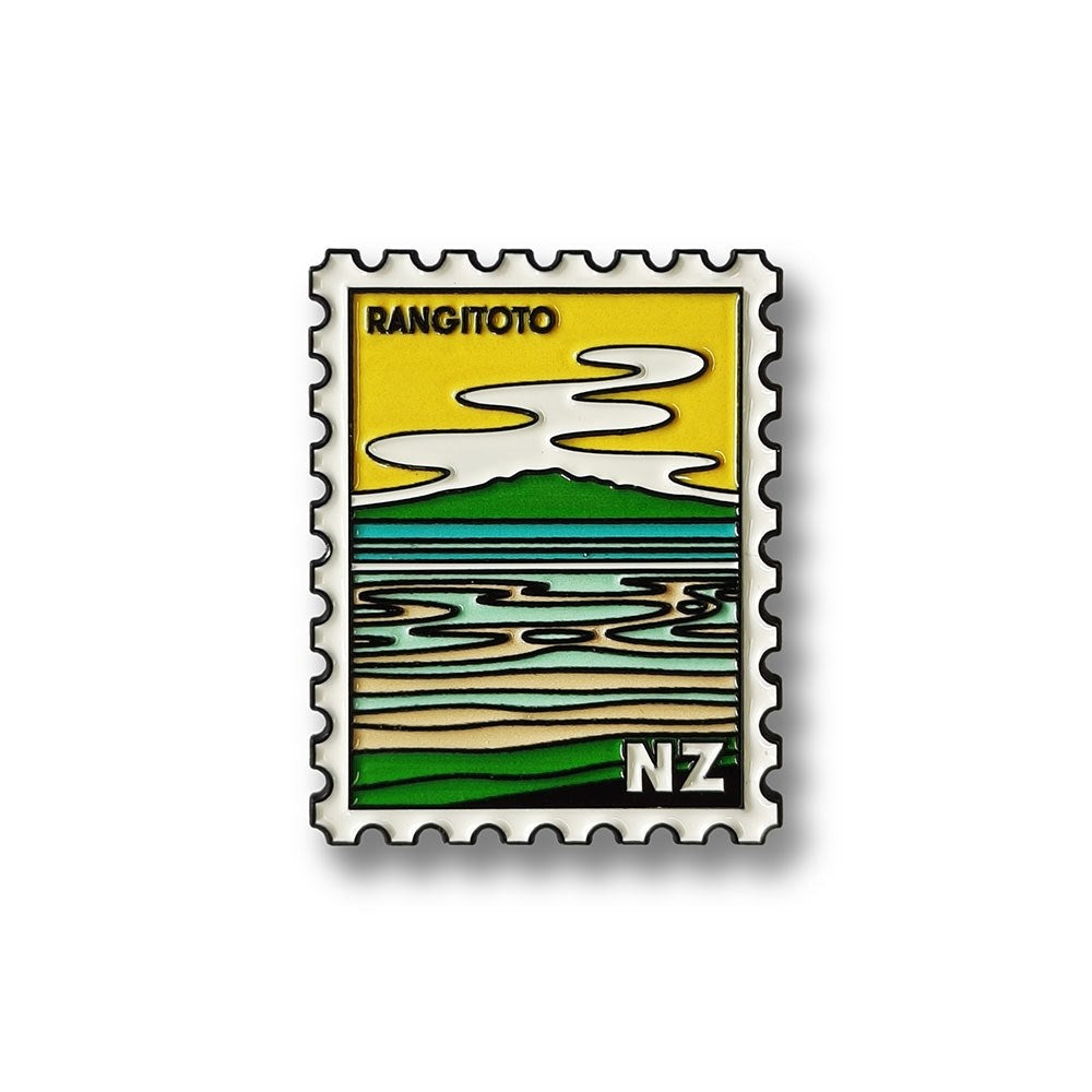 The Rangitoto Collectible Stamp Magnet features green hills, blue water, a sandy shore, yellow sky with stylized clouds, and NZ in the corner—an ideal Glenn Jones Artwork enamel collectible.