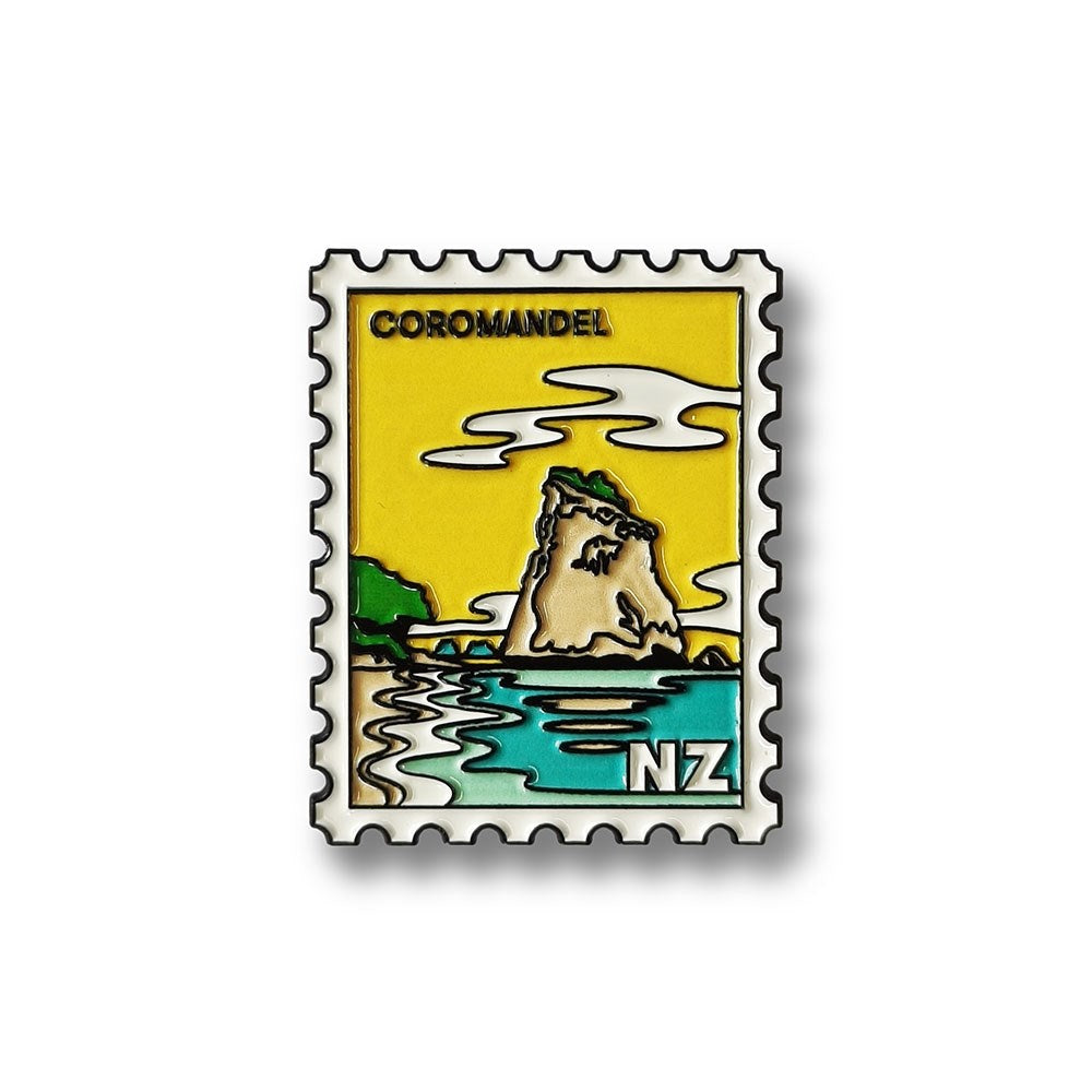 The Coromandel Collectible Stamp Magnet features a stylized coastal rock formation, blue water, clouds, and COROMANDEL with NZ—a unique New Zealand collectible with iconic design.