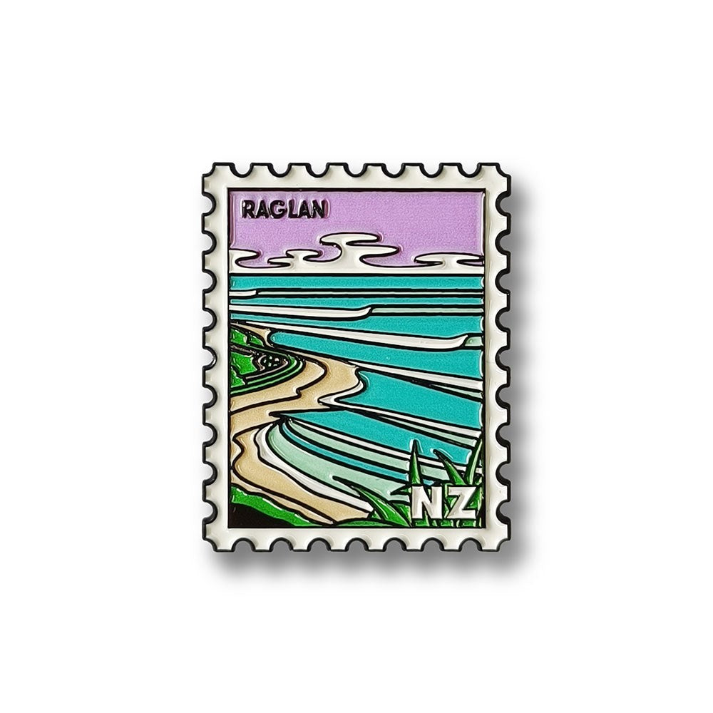 The Raglan Collectible Stamp Magnet by Glenn Jones showcases a stylized New Zealand coastal scene with waves, shoreline, and “NZ” in the corner, detailed in black outlines and pastel colors—a unique addition for Kiwi design lovers.