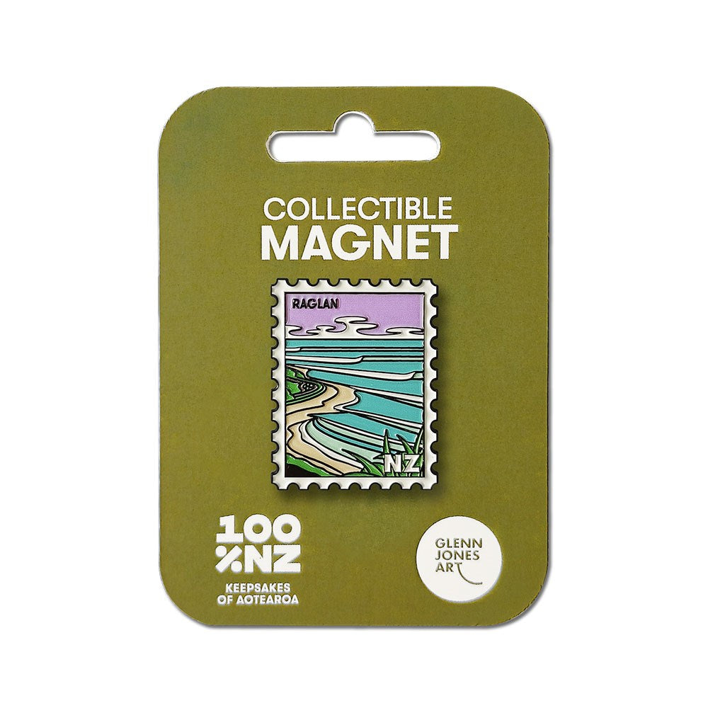 The Raglan Collectible Stamp Magnet, designed by Glenn Jones, is an enamel magnet shaped like a postage stamp with a stylized coastal scene. It comes on a green backing card labeled Collectible Magnet and 100% NZ.