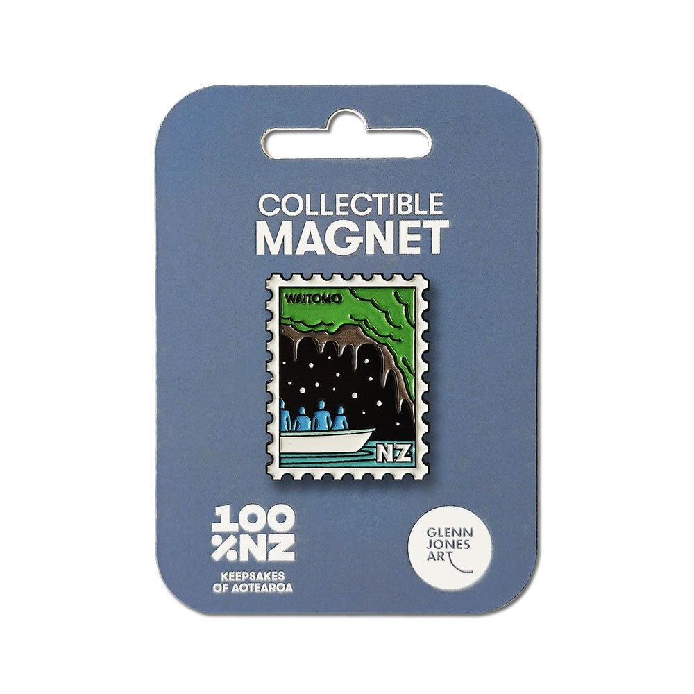 The Waitomo Collectible Stamp Magnet features Glenn Jones’ illustration of a New Zealand cave boat tour with four people and glowworms above, shaped like a postage stamp and displayed on blue packaging.