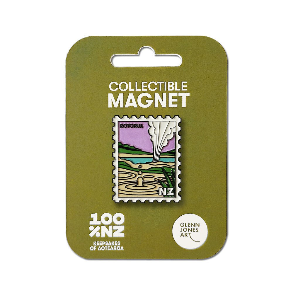 The Rotorua Collectible Stamp Magnet is an enamel magnet shaped like a postage stamp, featuring a stylized illustration of Rotoruas geysers and thermal pools, on a green backing card labeled Collectible Magnet.