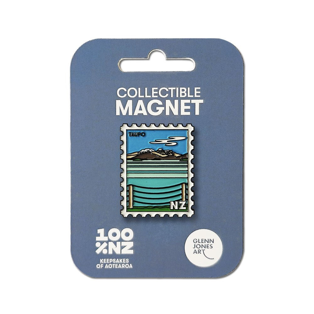 The Taupo Collectible Stamp Magnet features Glenn Jones’s Lake Taupō illustration on a rectangular enamel magnet, mounted on blue “COLLECTIBLE MAGNET” packaging—an ideal NZ keepsake from Glenn Jones Art.