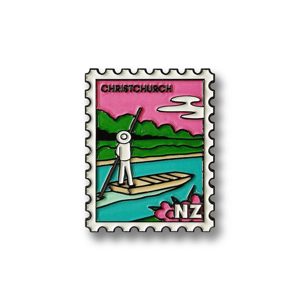 A magnet styled as a postage stamp features a cartoon figure on a boat in a river, pole in hand, with green trees and pink sky. Text reads CHRISTCHURCH and NZ—an iconic Glenn Jones Artwork Christchurch Collectible Stamp Magnet.