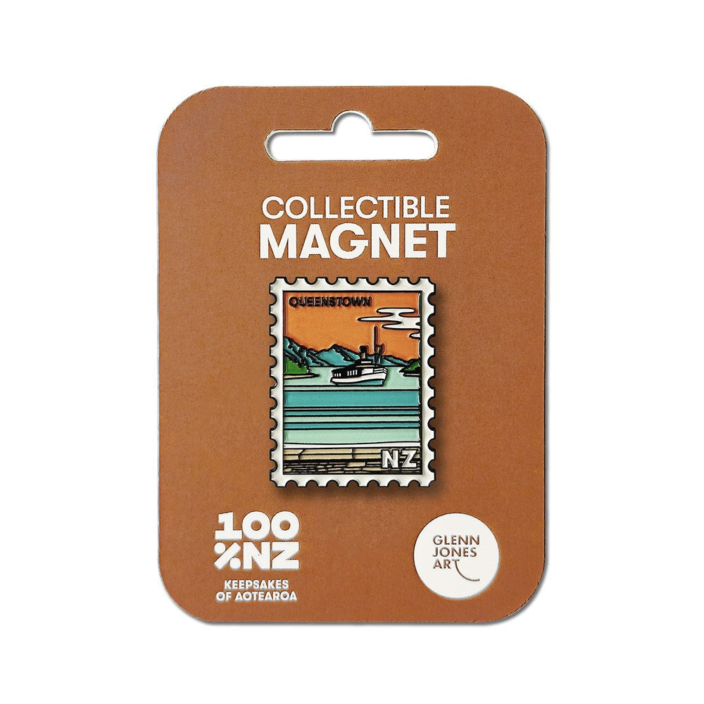 The Queenstown Collectible Stamp Magnet features Glenn Jones artwork of a boat on a lake at sunset, Queenstown NZ text, and comes in brown packaging labeled Collectible Magnet and 100% NZ.