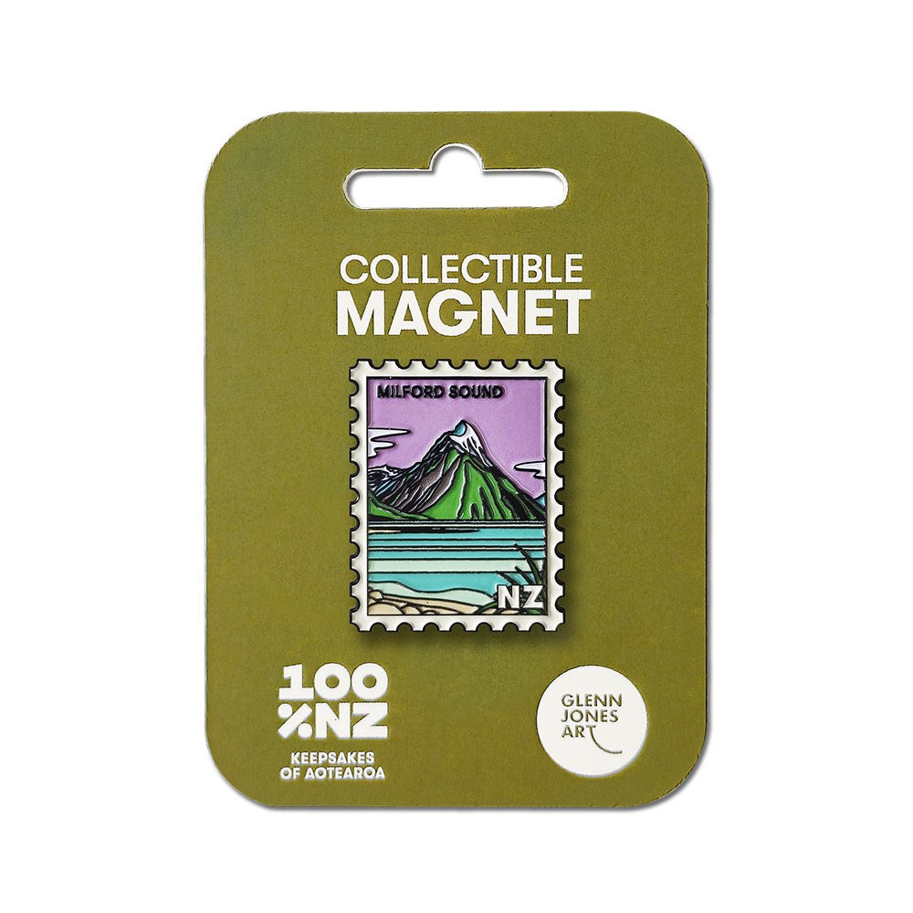 The Milford Sound Collectible Stamp Magnet by Glenn Jones features a postage stamp-shaped enamel design with a mountain and water illustration. It comes attached to a green backing card labeled Collectible Magnet.