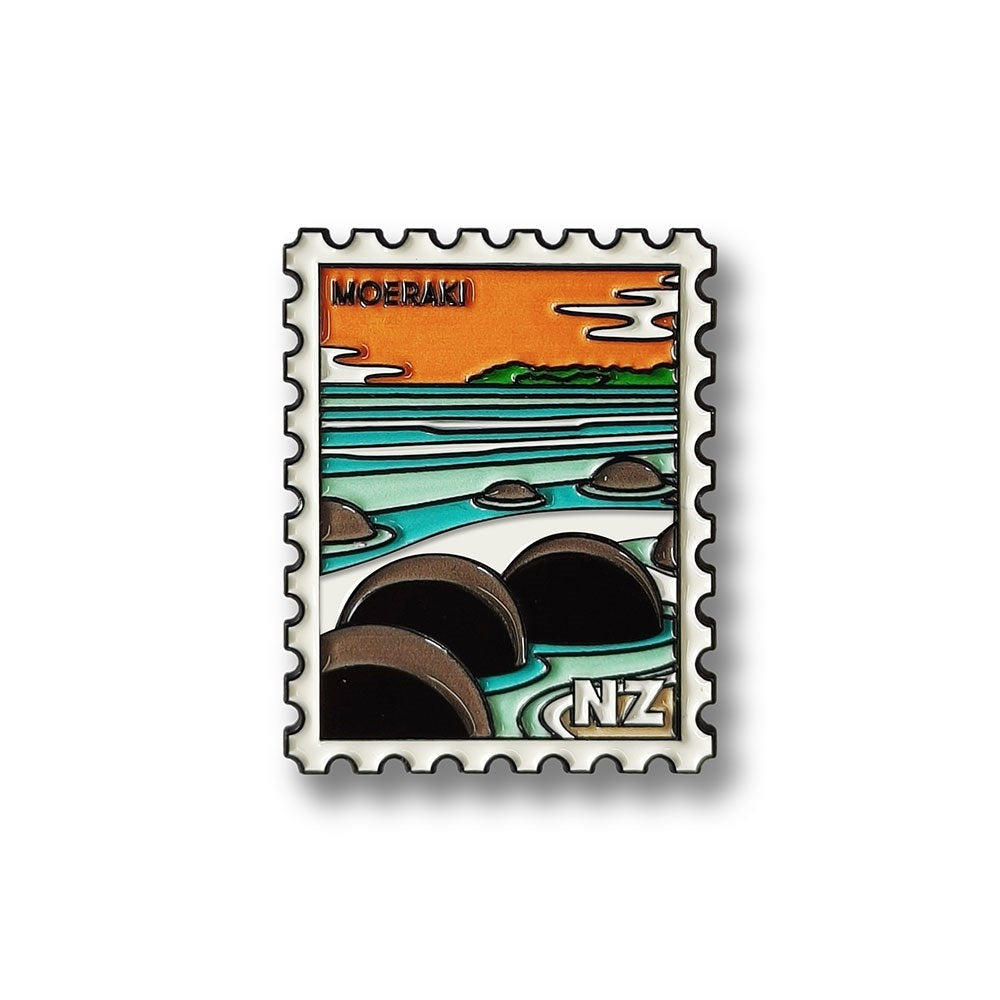 The Moeraki Collectible Stamp Magnet features stylized round rocks on a beach with ocean waves, an orange sky, and the text MOERAKI and NZ in Glenn Joness design.