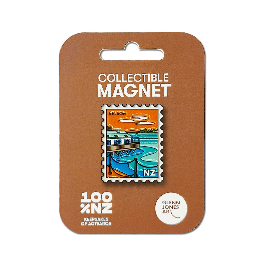Introducing the Nelson Collectible Stamp Magnet: a unique enamel magnet shaped like a postage stamp, featuring a coastal scene labeled "Nelson NZ." Presented on brown packaging marked with "Collectible Magnet" and "100% NZ Keepsakes of Aotearoa – Glenn Jones Art," this distinctive New Zealand souvenir is perfect for magnet collectors and enthusiasts.