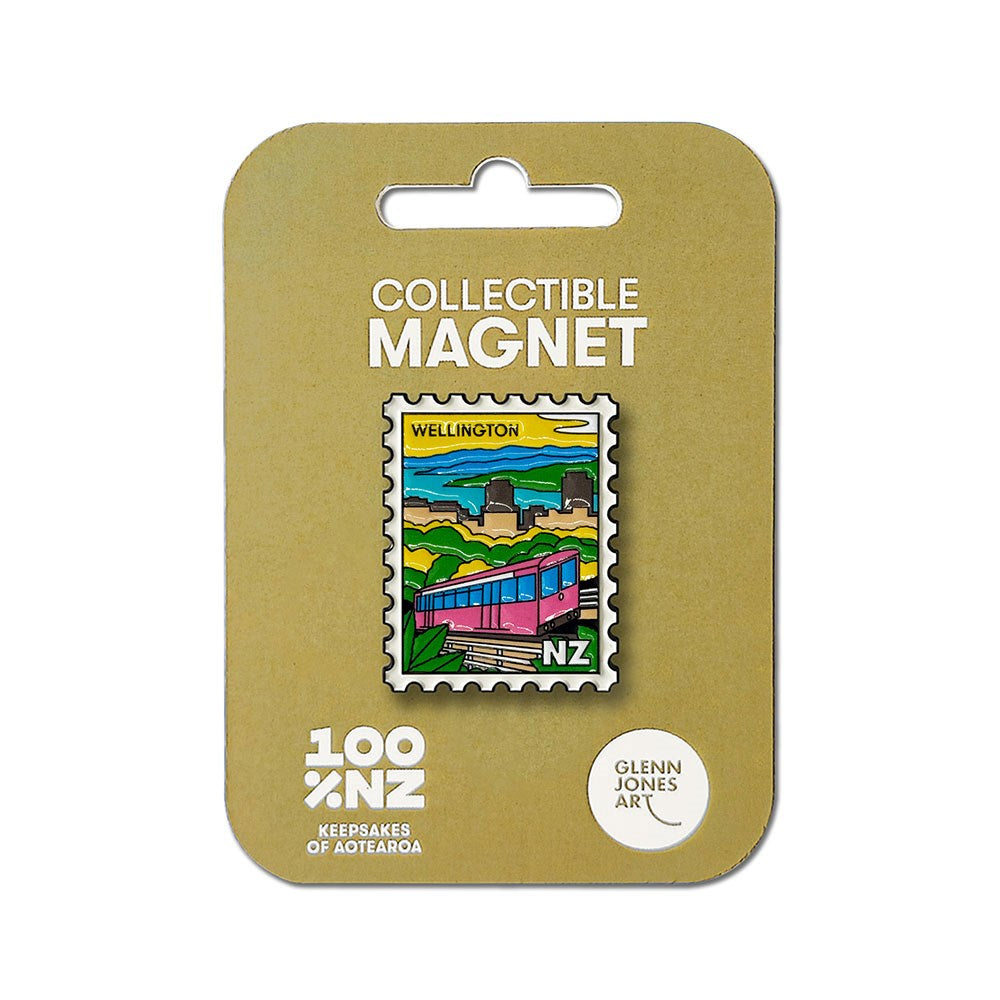 The Wellington Cable Car Collectible Stamp Magnet is shaped like a postage stamp and showcases a vibrant illustration of the iconic cable car along with hills, sky, and city buildings—a perfect keepsake to celebrate New Zealand. The packaging features the text: "Collectible Magnet, 100% NZ, Keepsakes of Aotearoa, Glenn Jones Art.