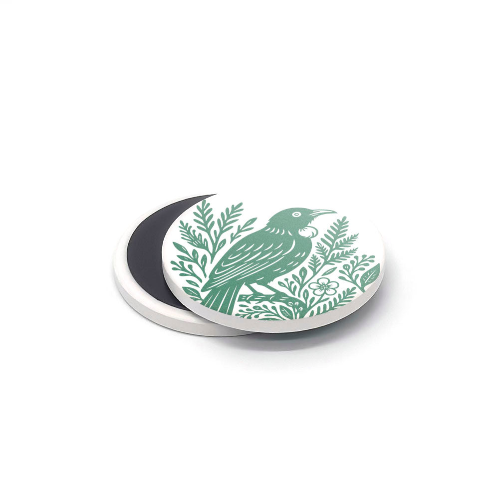 The Woodcut Ceramic Magnet Set features round white ceramic magnets with green bird and leafy branch illustrations, partially overlapping on a white background—perfect New Zealand souvenir or printed ceramics gift.