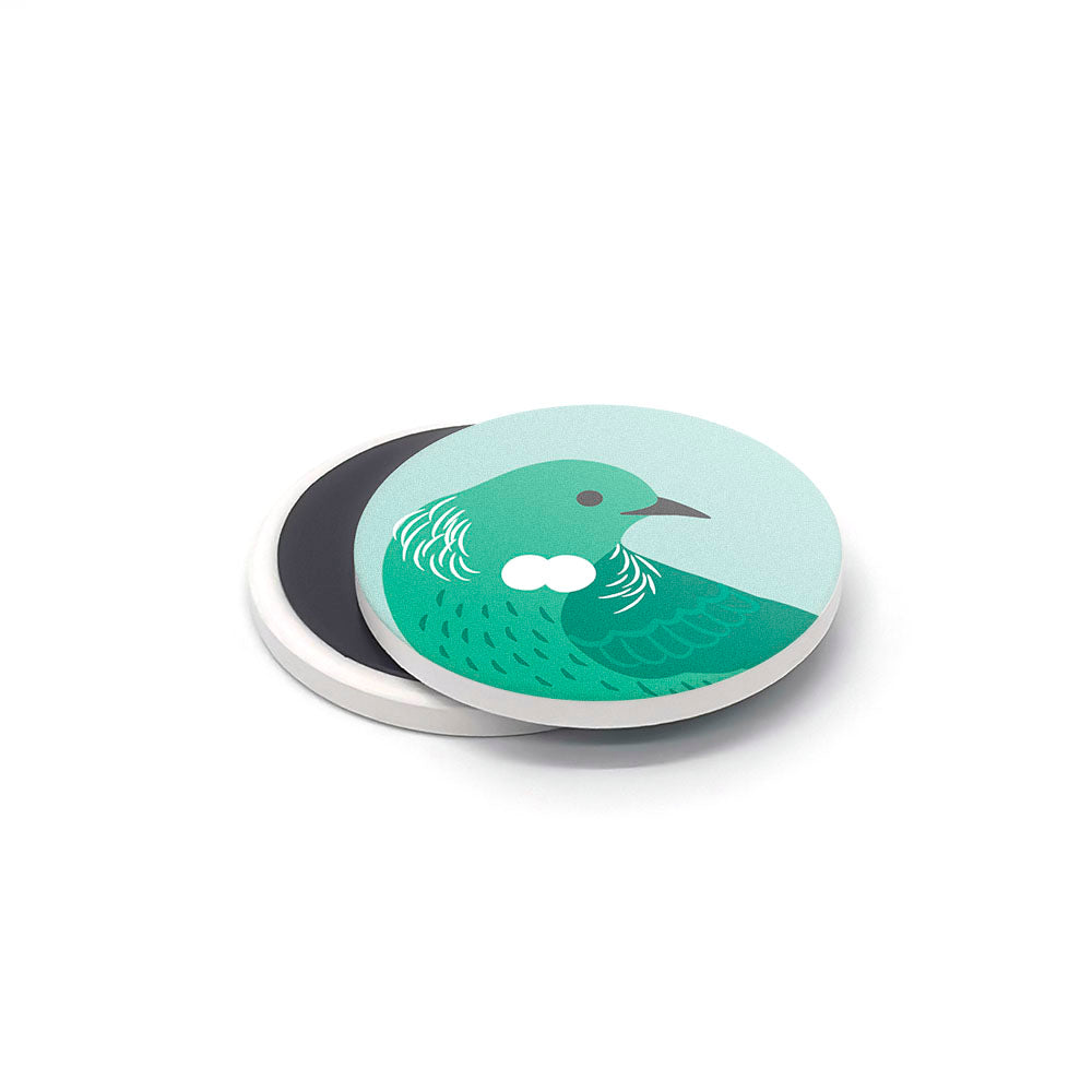 The Storybook Ceramic Magnet Set, made in New Zealand, showcases a green bird with white neck markings on one magnet, alongside a second plain black and white magnet, both set against a white background.