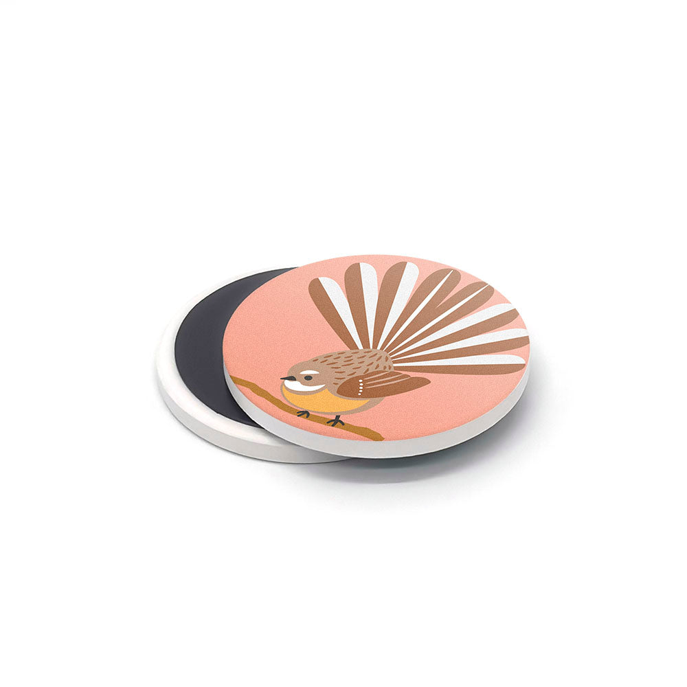 The Storybook Ceramic Magnet Set includes a round magnet made in New Zealand, showing a brown bird with a fanned tail on a branch with a pink background and white edges.