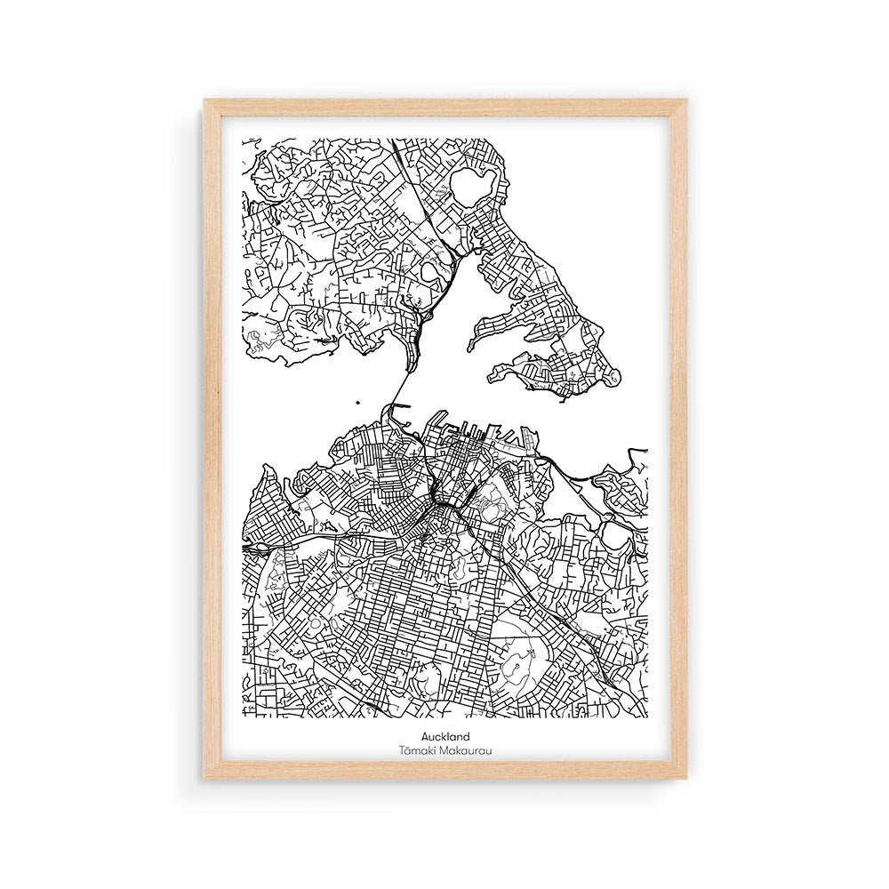 The Auckland Mapscape is a black and white map of New Zealands Auckland, showing detailed street layouts. Printed with archival inks on 200gsm art paper, it comes in a light wooden frame and is labeled “Auckland Tāmaki Makaurau” at the bottom.