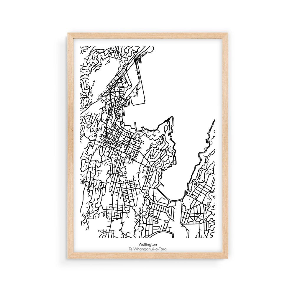 The Wellington Mapscape is a black-and-white, minimalist line art map of Wellington, New Zealand, featuring detailed streets and topography. Printed with archival inks on a white background and set in a light wood frame.