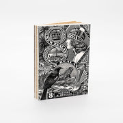 The NZ Stamp Notebook features a black and white cover with vintage New Zealand postage stamps, including a bird and womans profile, exposed binding, and is proudly printed in New Zealand.
