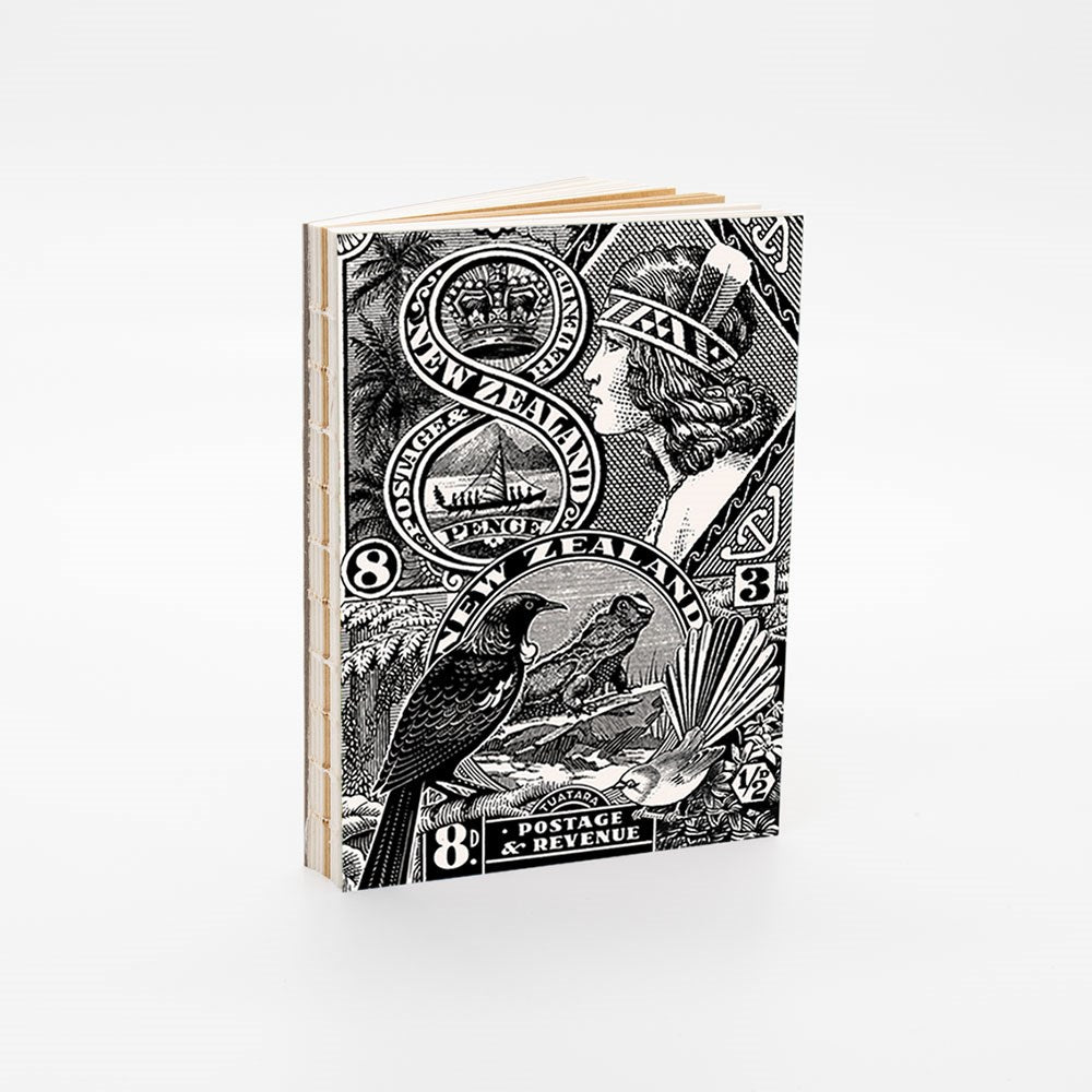 The NZ Stamp Notebook features a black and white cover with vintage New Zealand postage stamps, including a bird and womans profile, exposed binding, and is proudly printed in New Zealand.