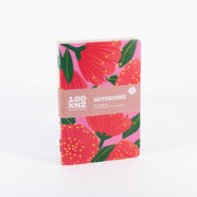 The Bright Botanical Notebook Set includes three hand-stitched notebooks with pink and red floral covers, wrapped in a brown paper band labeled 100% NZ Notebooks – New Zealand Bright Botanical Collection. Quality paper ensures great writing.
