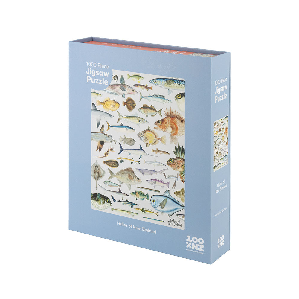 The Fishes of NZ Jigsaw Puzzle is a blue 1000-piece box featuring detailed illustrations of New Zealands unique marine fish species on the front.