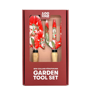 The NZ Pohutukawa Garden Tool Set includes a trowel and fork with ash wood handles and red and green floral patterned blades, packaged in a box labeled New Zealand Pōhutukawa Garden Tool Set.
