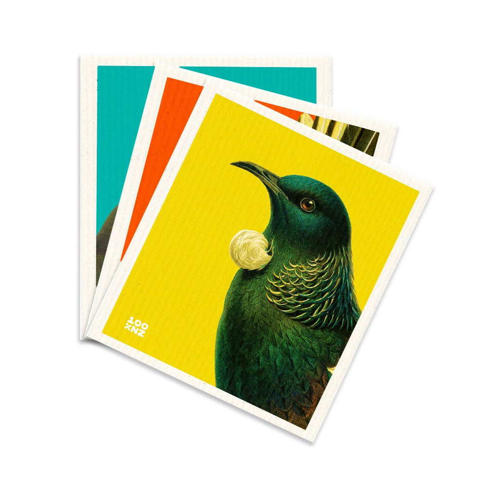 Three colorful Swedish Dishcloths - Bright Birds overlap, with the top dishcloth showing a green bird with a white tuft on its neck against a bright yellow background, capturing playful Kiwiana imagery.