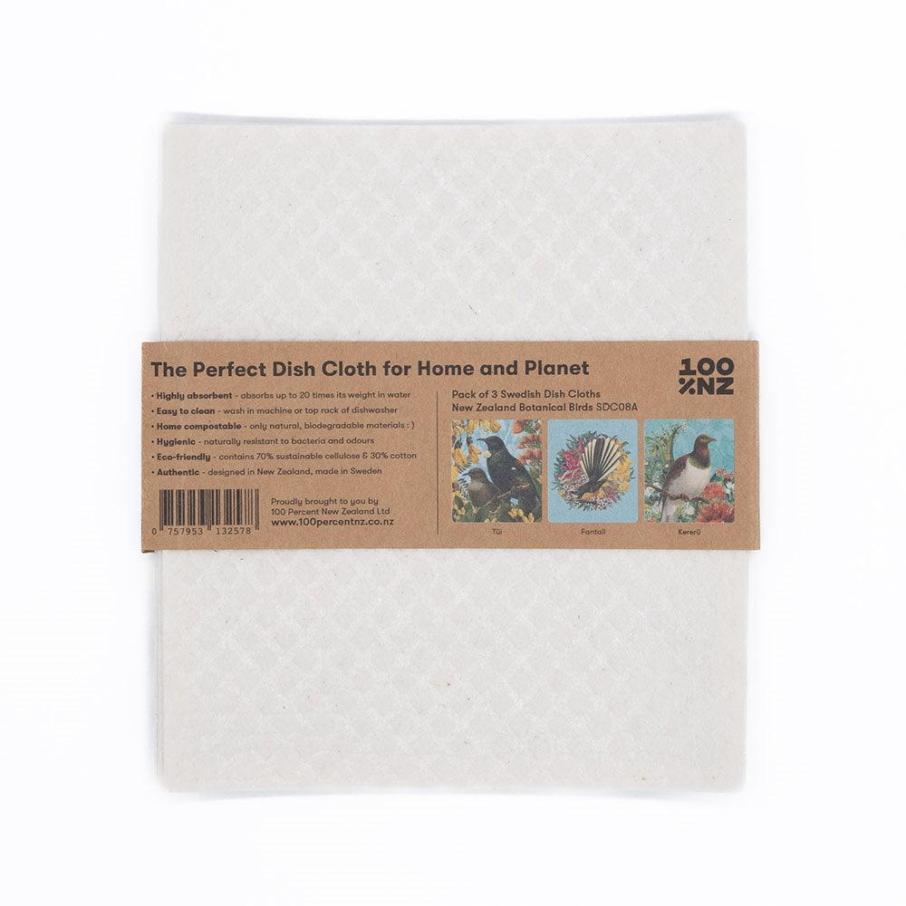 The Swedish Dishcloths - Botanical Birds is a white dish cloth wrapped in a brown paper label featuring eco-friendly text, three bird illustrations, a barcode, and the phrase “The Perfect Dish Cloth for Home and Planet.”.