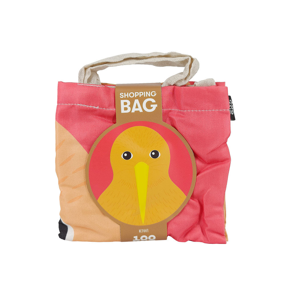 The Bright Kiwi Shopping Bag is a lightweight, reusable bag with two fabric handles, folded in packaging featuring a printed kiwi bird’s face and label—ideal for anyone looking for an affordable shopping bag.