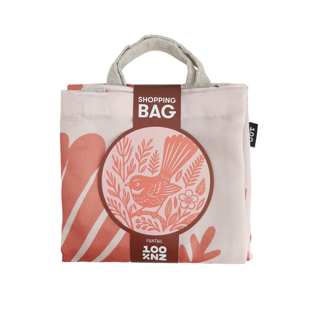 Woodcut Fantail Shopping Bag, a folded, New Zealand-designed reusable bag featuring a circular graphic of a fantail bird, botanical elements, and the text SHOPPING BAG and FANTAIL 100% NZ.
