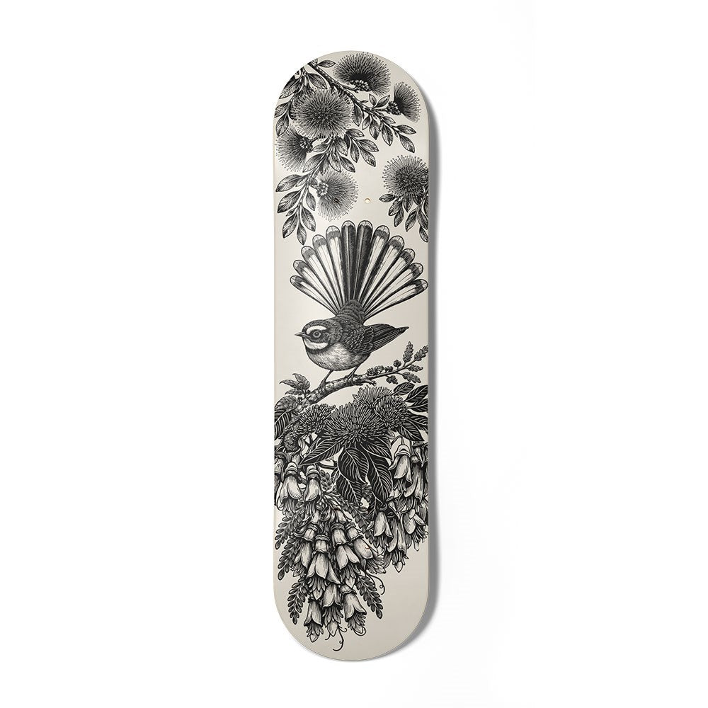 The In Bloom Skateboard Deck is a Canadian maple deck showcasing a black and white bird with fanned tail feathers on a branch among NZ flora—a striking piece of contemporary art.