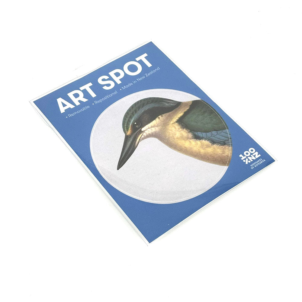 A blue “Hushed Blue Kingfisher Art Spot” card shows a bird’s head in a circle, with text: “Removable,” “Reusable,” and “Repositionable wall art.” The 100% NZ logo appears at the bottom right.