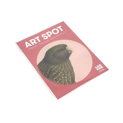 The Hushed Pink Kakapo Art Spot is a rectangular card with the title ART SPOT, a kakapo illustration on a pink background, and text noting it’s removable, reusable, made in New Zealand. Matte fabric finish and logo appear in the lower right corner.