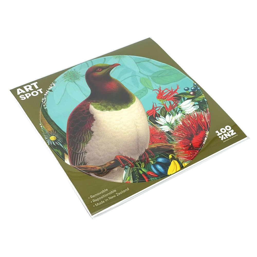 The Botanical Kereru Art Spot is a square print of an illustrated bird with green and maroon feathers among vibrant flowers. Its matte finish and reusable adhesive let you easily reposition it on any wall.
