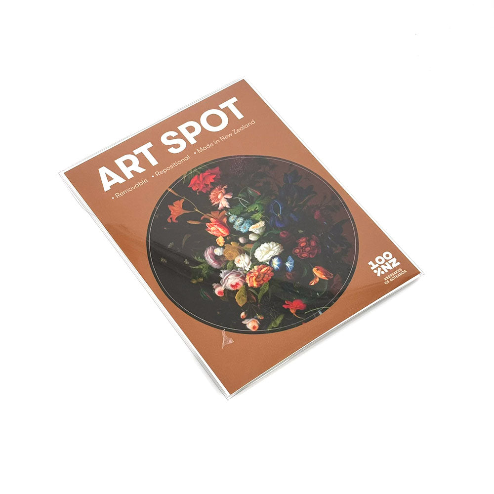 The Vintage Flowers Art Spot jigsaw puzzle box features a round, colorful floral painting on brown, with 100 XL pieces. Made in New Zealand, the puzzle includes repositionable wall art for versatile display.