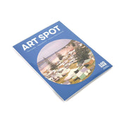 Retro Camping Art Spot is a magazine with a blue cover showing an aerial view of a coastal campsite with tents and caravans. It highlights Remarkable Inspiration Made in New Zealand and includes stunning matte-finish, repositionable wall art.