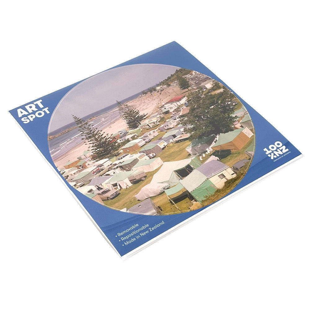 Retro Camping Art Spot is a square booklet with a matte fabric finish, featuring a circular campsite photo on the cover. “Remarkable,” “Reproducible,” and “Made in New Zealand” are noted, plus the 100% NZ logo in the corner.