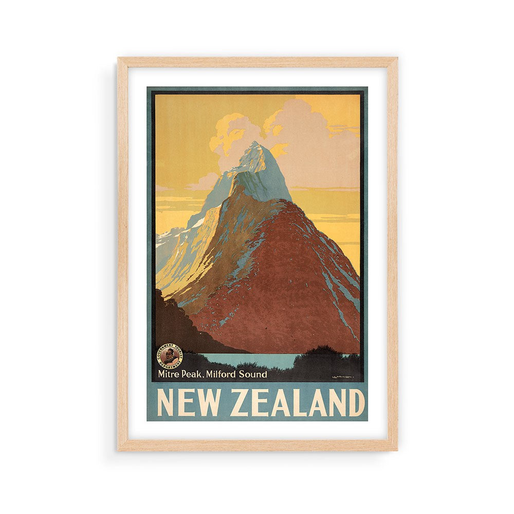 The Mitre Peak Tourist Print is a framed, vintage-style poster featuring a stylized mountain and yellow-orange sky with Mitre Peak, Milford Sound and NEW ZEALAND—a must-have archival print for collectible poster enthusiasts.