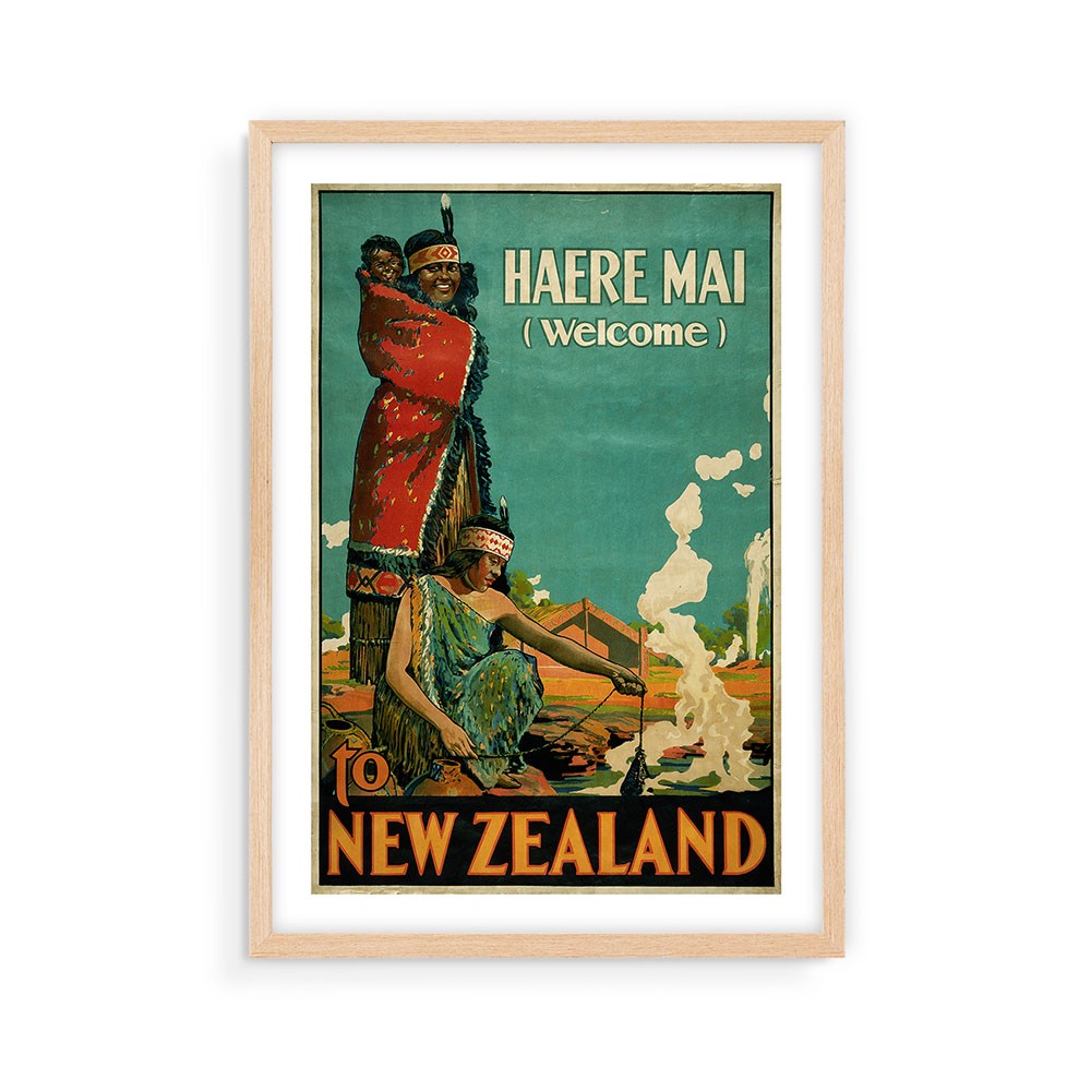 The Haere Mai Tourist Print is an archival vintage-style poster showing a Māori family by a fire on a green background. Framed in light wood, its perfect for fans of collectible New Zealand travel art.