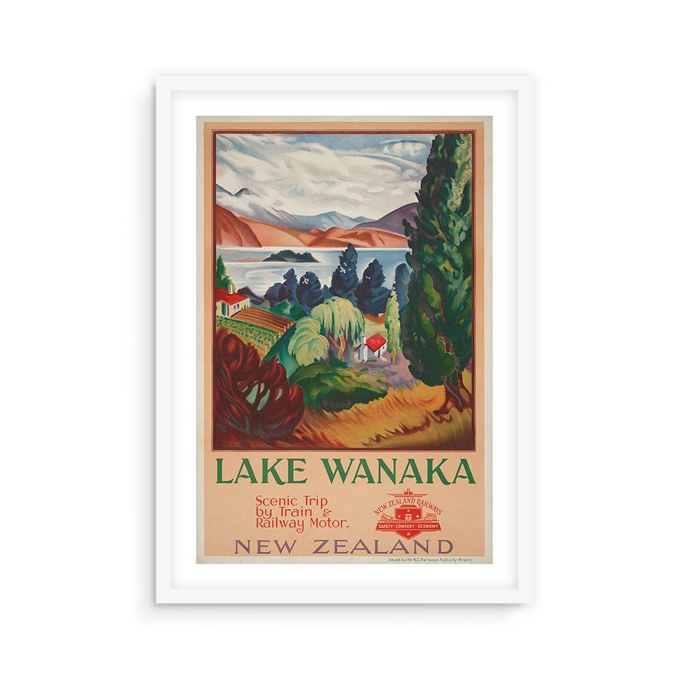 Framed Lake Wanaka Tourist Print from New Zealand, showcasing a scenic landscape of trees, water, and mountains. Features the text: “Lake Wanaka – Scenic Trip by Train & Railway Motor – New Zealand.”.