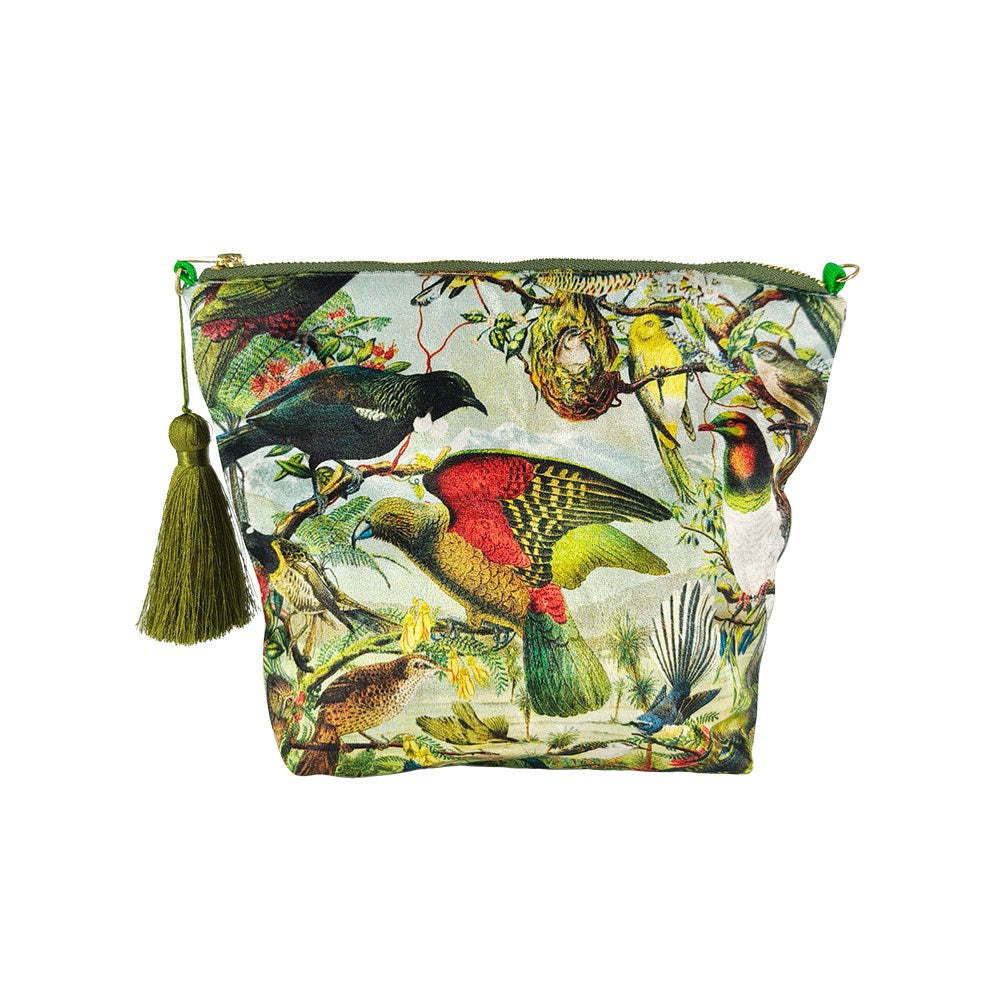 The NZ Native Birds Velvet Cosmetic Bag features a green tassel and a vibrant print of New Zealand birds and foliage on a light background—perfect for gifting or keeping your cosmetics stylishly organized.