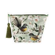 The Chatty Fantails Velvet Cosmetic Bag is a stylish New Zealand-designed pouch with a green tassel and bird-and-blossom illustration on light green—ideal as a charming gift.