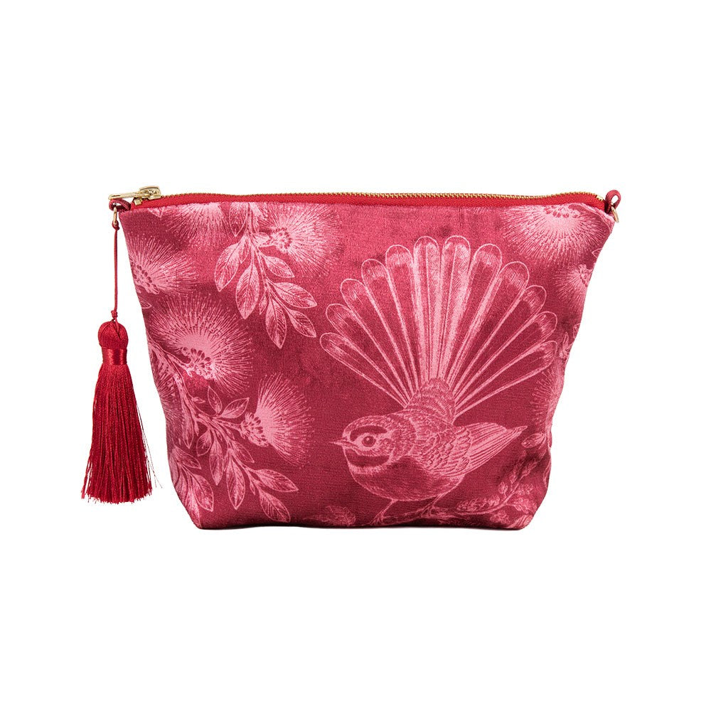 In Bloom Velvet Cosmetic Bag features a red velvet exterior, gold zipper, red tassel, and printed floral and bird design. Designed in New Zealand and shown on a white background.