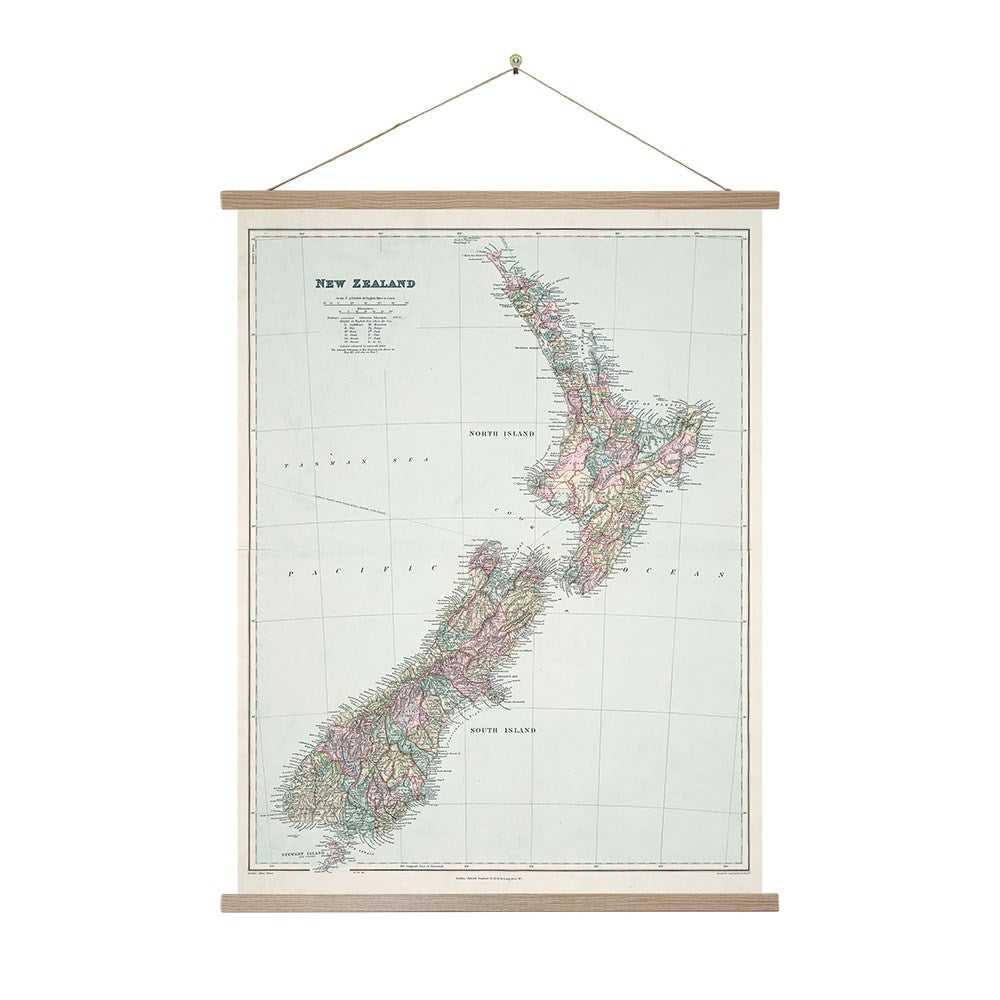 The Map of New Zealand Wall Chart features a vintage-style display of the North and South Islands with labeled regions, cities, and major landmarks in a wooden frame with hanging string. Made in New Zealand.